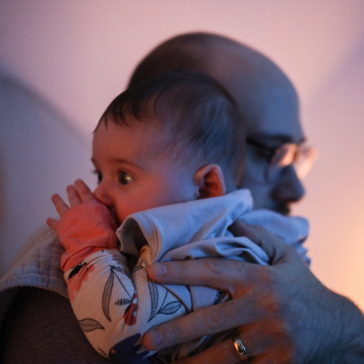 A baby being held by a dad
